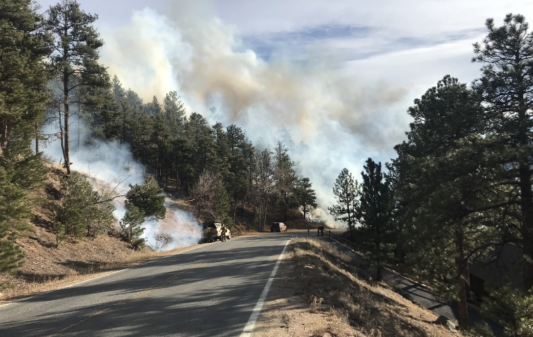 Wildfire smoke along a Boulder County roadway.